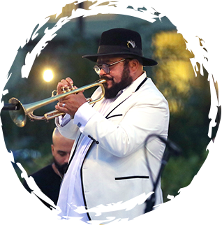 man with black hat playing trumpet