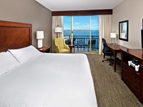 Bay View King room with view to bay and large bed with white linen
