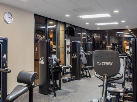 Hotel gym with exercise equipment and mirrors