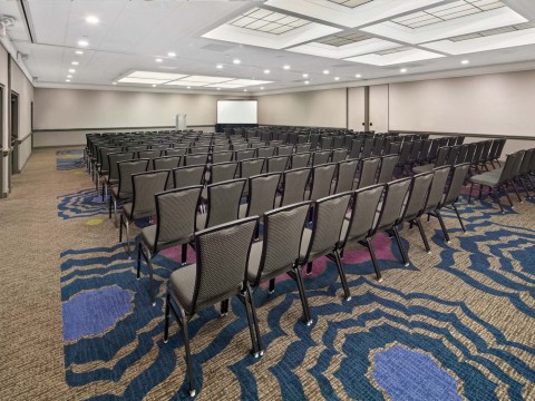 Coast Ballroom meeting space with chairs and a screen