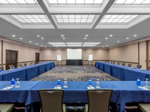 Coast Ballroom meeting space with a screen and tables