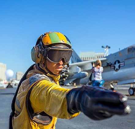 USS Midway personel directing an aircraft