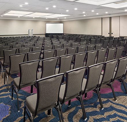 Coast Ball Room setup for a meeting with rows of chairs and seating