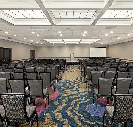 Coast Ball room with rows of seating in brightly lit room