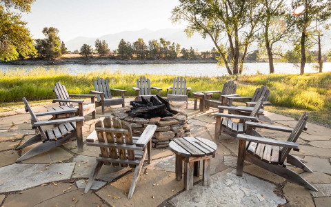 Wooden chairs around a fire pit