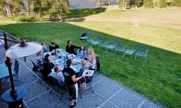 Outdoor dining patio overlooking a large field