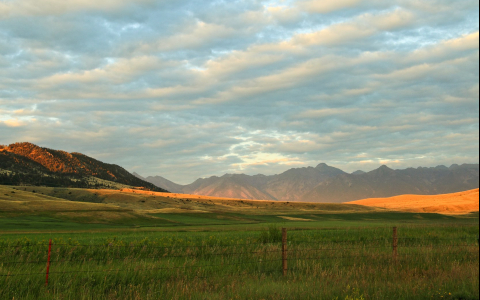 Vast field surrounded by mountains 