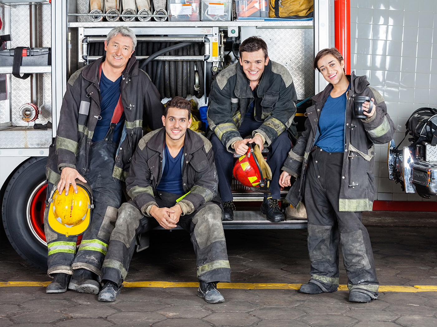 firefighters standing around a firetruck