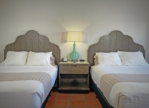 Two queen beds with a  lamp