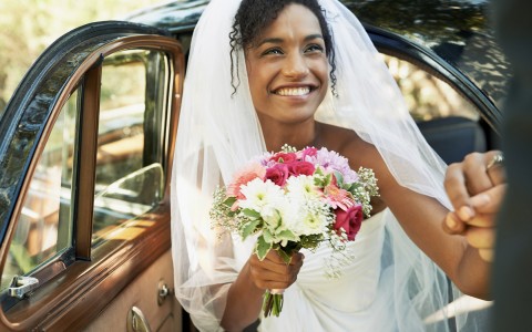 smiling bride stepping out of the car