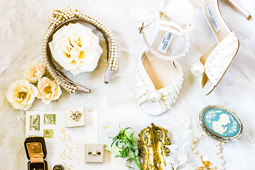overhead view of white wedding shoes and other wedding accessories 