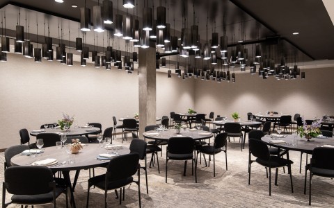meeting venue with round tables and black chairs 