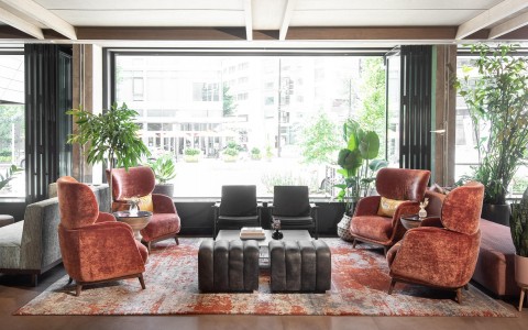 lounge area with orange and black chairs 