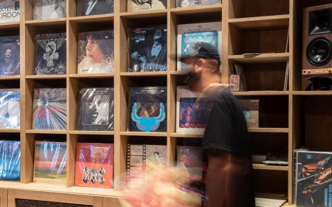 man with records in record store 