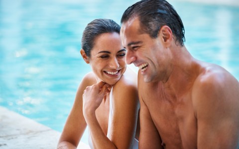 Couple laughing in pool