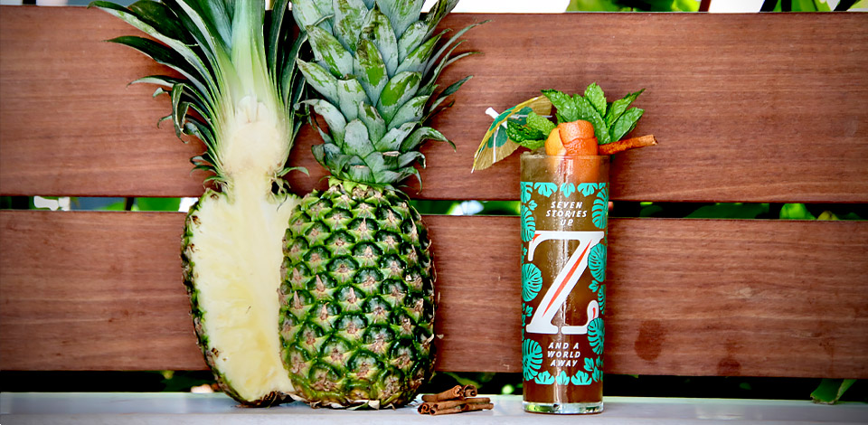 zanzibar cocktail next to cut whole pineapple