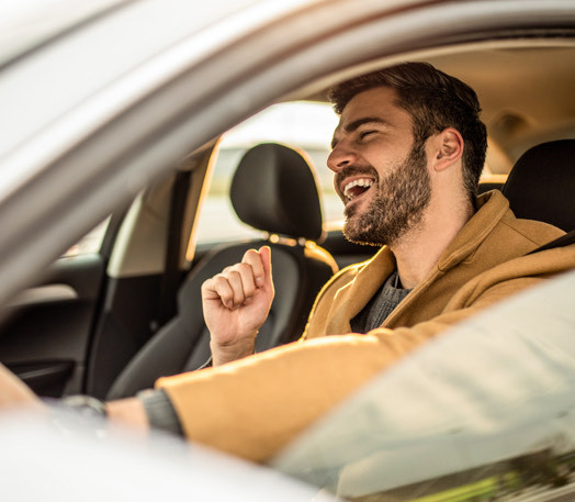 man smiling in car
